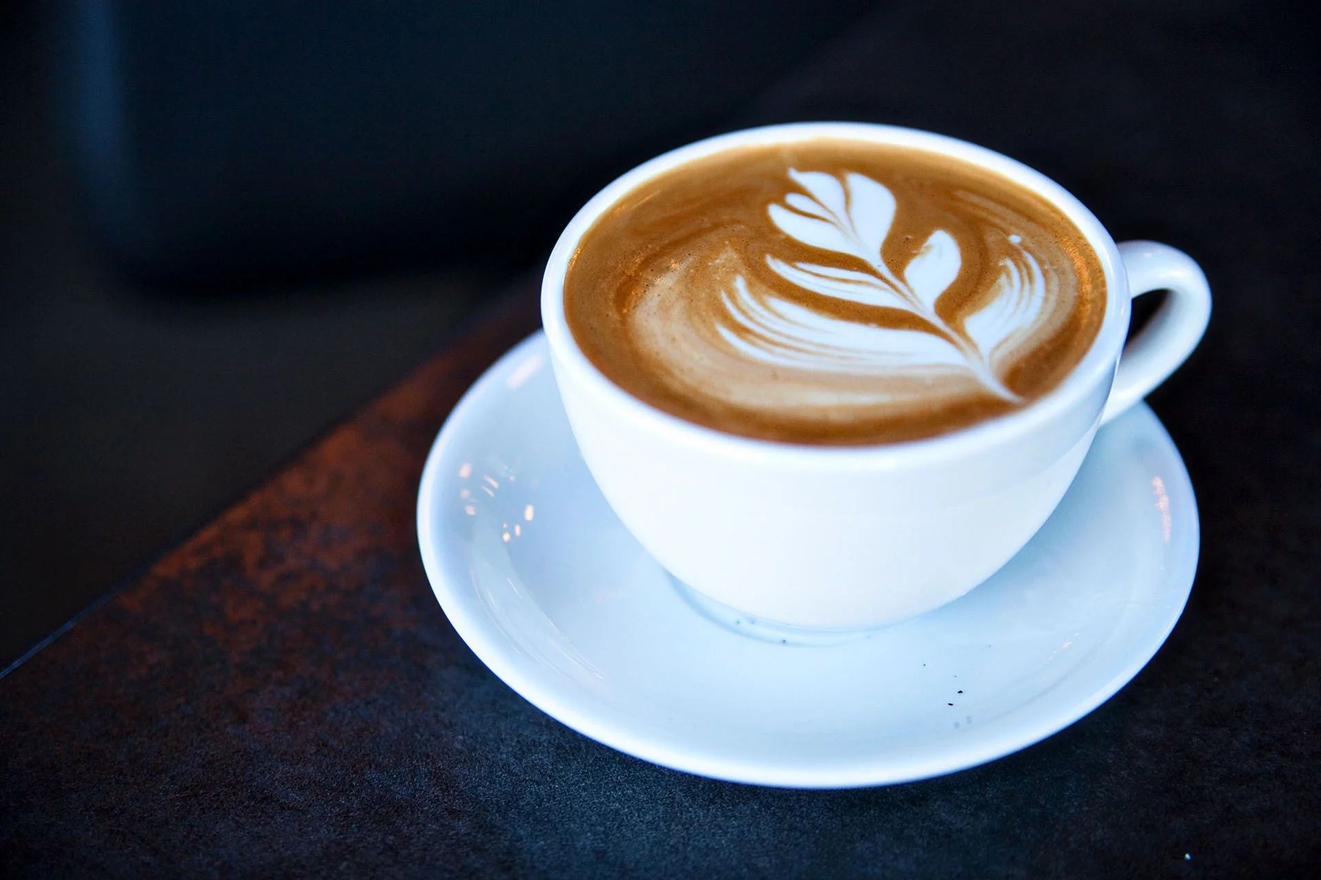 A rosetta latte on a saucer