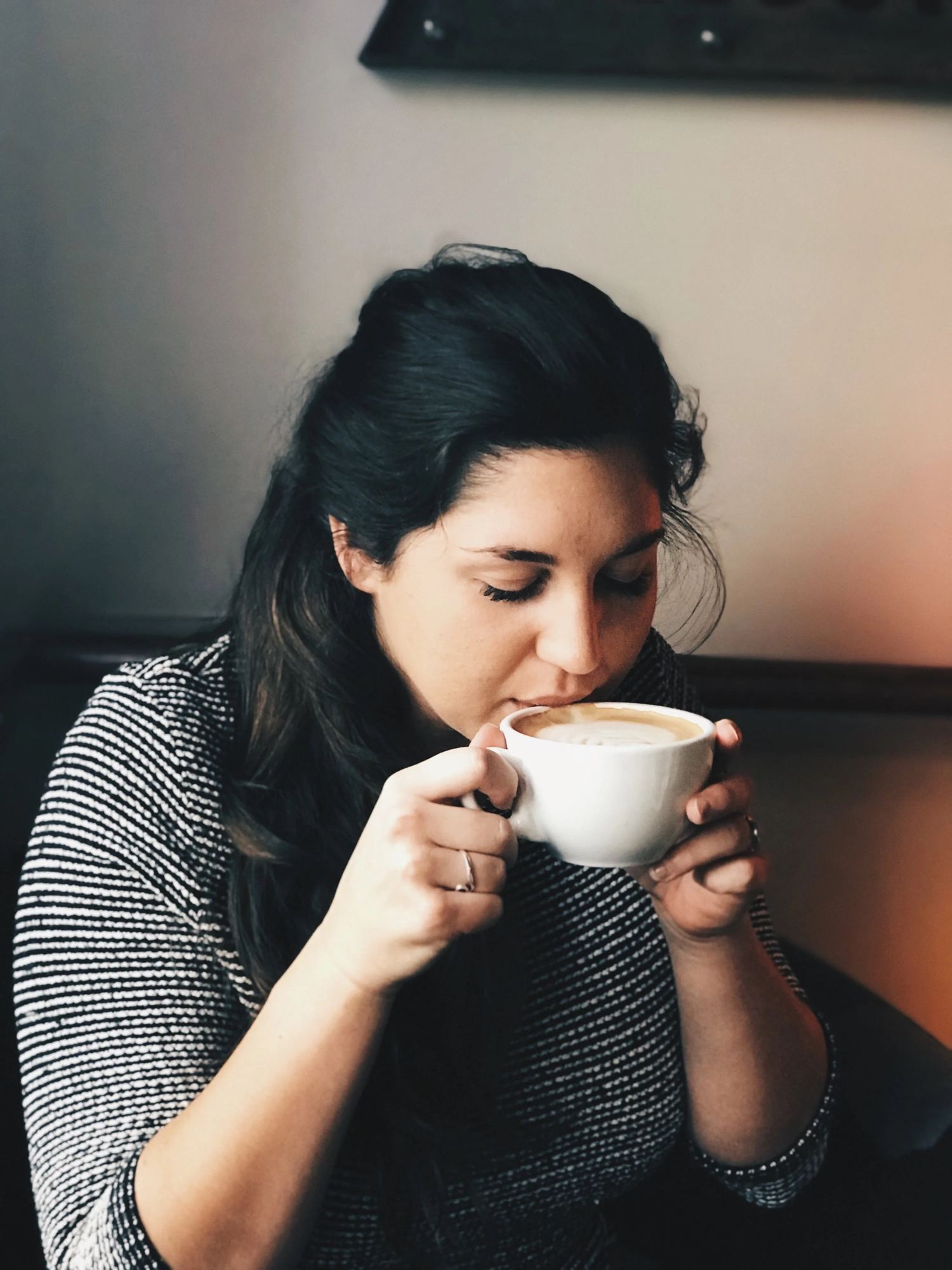 A customer taking a sip of a latte at Buckhead